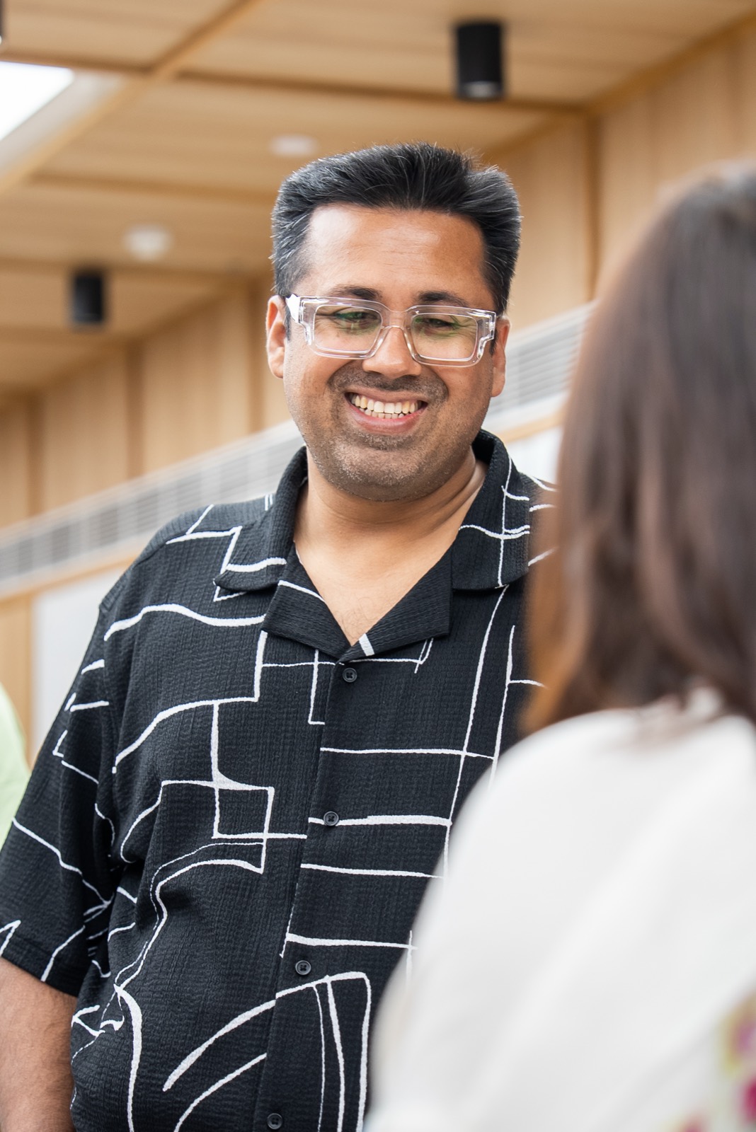 An attendee listening during a session at Miles Ahead Delhi